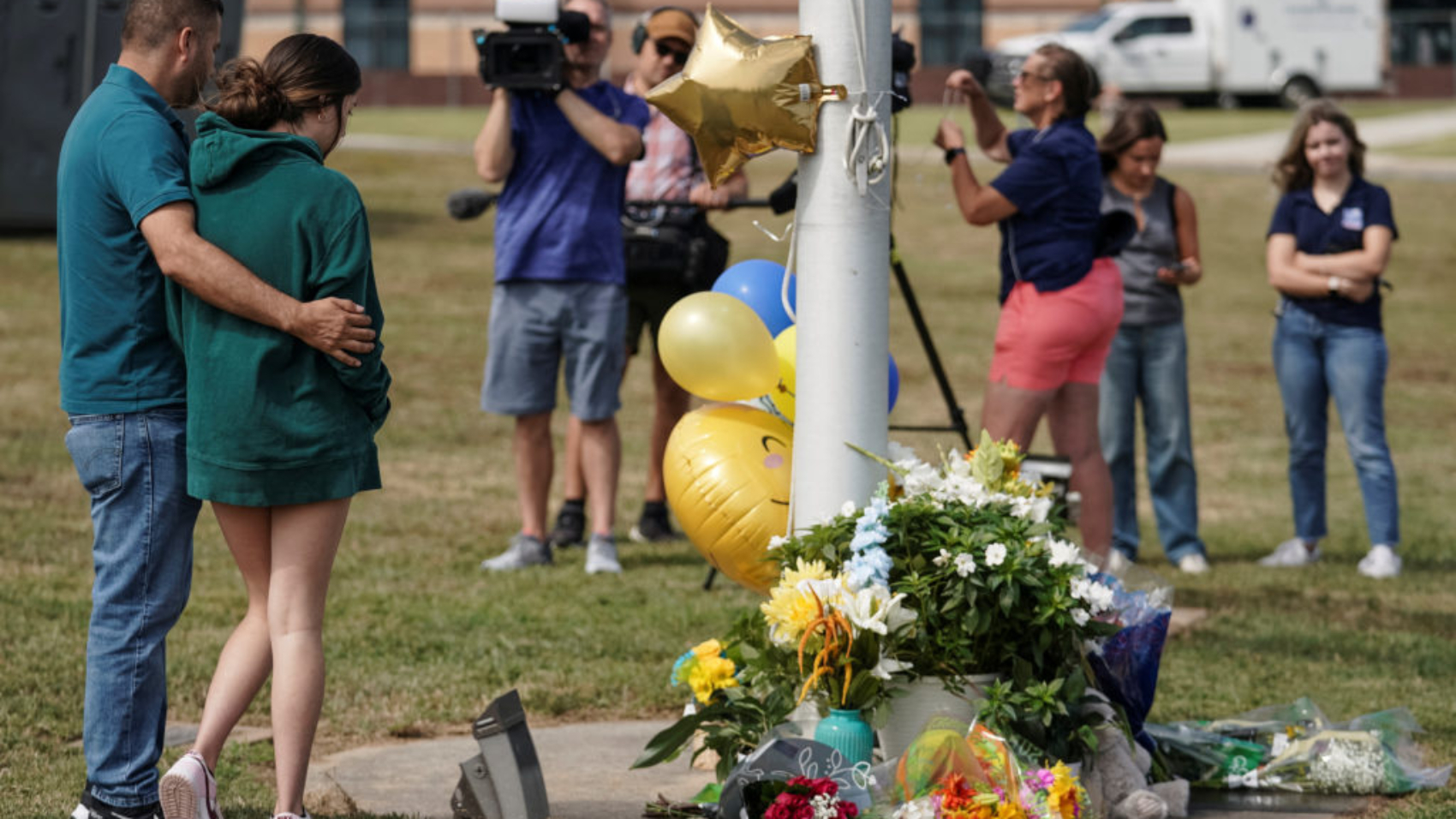 People pay their respect at a makeshift memorial at Apalachee High School the day after a fatal shooting left four dead in Winder, Georgia, U.S. September 5, 2024. REUTERS/Elijah Nouvelage