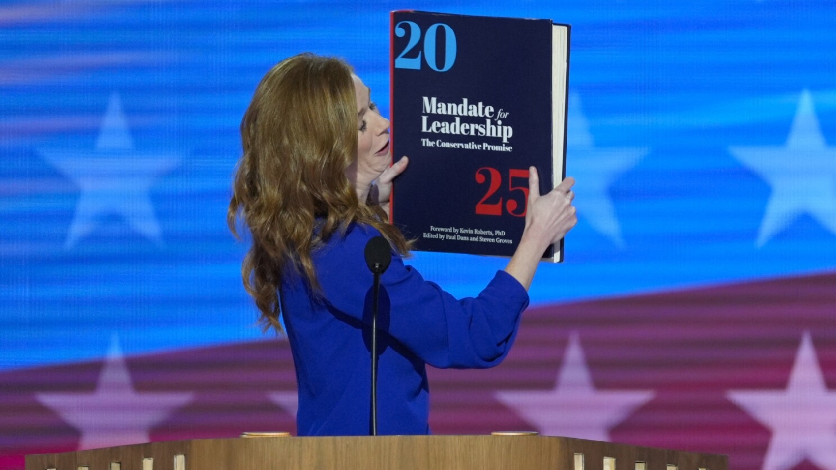 Michigan State Senator Mallory McMorrow holding up a book during her remarks at the Democratic National Convention on Monday, Aug. 19, 2024, in Chicago. (AP Photo/J. Scott Applewhite)
