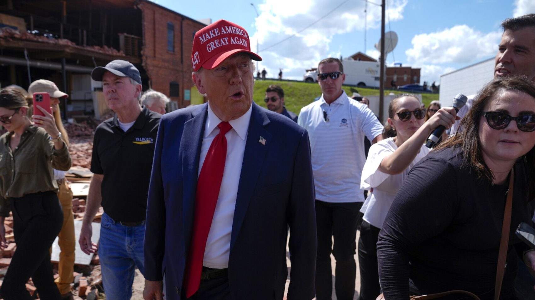 Republican presidential nominee former President Donald Trump walks outside the Chez What furniture store as he visits Valdosta, Ga., a town impacted by Hurricane Helene, Monday, Sept. 30, 2024. (AP Photo/Evan Vucci)