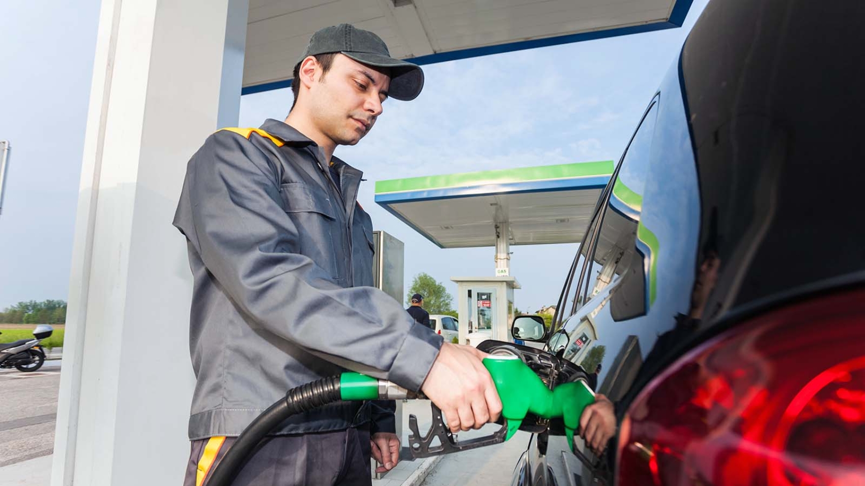 Gas station assistant refueling a car